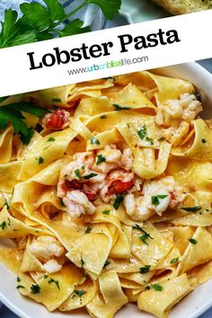 lobster pasta in a white bowl with bread and parsley on the side text reads lobster pasta