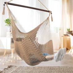 a person laying in a hammock with their feet propped up on the floor