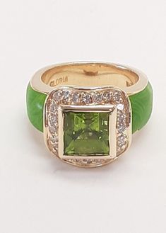 PERIDOT DIAMOND GREEN ENAMEL 14 KT GOLD RING-13.3GR SIZE=6.5 FINE DESIGN GLDRM STAMPED The item pictured is the exact item you will receive so view the photos carefully as they are part of the description A Authentic GLDRM Periodot & Diamonds Ring That Is Masterfully Crafted From Solid 14 Karat Yellow Gold and Green Enamel. This Beautiful Box Designed Ring Features Approximately 3.0 Carat Green Peridot Princess Cut  And 0.40 Carats Of Round Brilliant Cut Diamonds (24 stones) G-H Color And VS In Clarity.  This piece measures approximately 14.5mm x 14.5mm at the top of the ring and shank tapering to 5.5mm, and will fit a size 6-1/2 finger. There are Genuine Hallmarks as well as Purity Stamps present on this Ring. This piece weighs approximately 13.3 Grams NOTE: Very Small piece of enamel is Green Enamel Ring For Formal Occasions, Luxury Green Jewelry With Polished Finish, Designer Green Jewelry As A Gift, Designer Green Jewelry For Gifts, Designer Green Jewelry As Gift, Hallmarked Green Enamel Ring For Anniversary, Green Hallmarked Enamel Ring For Anniversary, Elegant Green Enamel Ring With Polished Finish, Green Enamel Round Ring