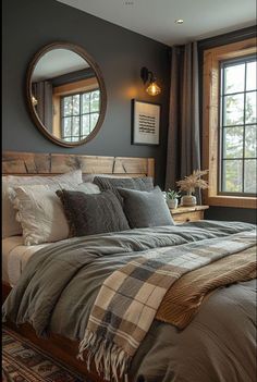 a large bed sitting under a round mirror in a bedroom next to a dresser and window