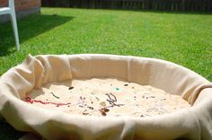 an empty dog bed in the grass