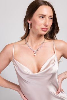 Our Bailey Glam Cubic Z Necklace Set is designed to elevate and enhance any look. The statement Necklace is detailed with an all around semi stones and rhinestone design, the adjuster allows you to wear this to your best fitting. Its the perfect everyday piece. SizeLength : 14 in.Extender : 4.5 in.Drop : 1.25 in. QualityOne Size. Adjustable fit. Oxidized Metal Coating for quality endurance. ImportedNECZ2031R Elegant Bridal Necklace With Jewels And Cubic Zirconia, Elegant Crystal Backdrop Necklace As Gift, Elegant Crystal Backdrop Necklace For Gift, Elegant Cubic Zirconia Drop Necklace, Elegant Bridal Choker Necklace, Elegant Pearl Pendant Chain Necklace, Elegant Pearl Necklaces With Jewels, Elegant Pearl Chain Necklace For Party, Feminine Evening Pearl Jewelry