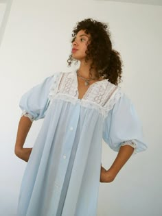 *Romantic vintage Christian Dior pale blue night robe with balloon sleeves and lace/eyelet/bow details.  Has pockets and button front closure. Fabric is a lightweight cotton gauze. *In excellent vintage condition. *Size not marked. Fits modern Small-Large. Shown on 5'5" frame. *Bust: 38" *Waist: 52" *Hip: 63" *Length: 56" *Fabric: Cotton. *Care: Hand wash in cool water; line dry. Vintage Light Blue Sleepwear With Lace Trim, Sleep Gown, Rich Fashion, Vintage Pajamas, Cotton Gowns, Linen Fashion, Vintage Nightgown, Blue Night, Vintage Christian Dior