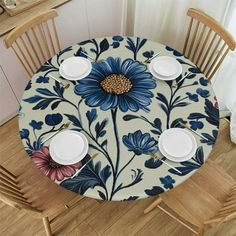 the table is set with plates and cups on it, which are decorated with blue flowers