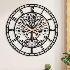 a wall clock that has a tree on it