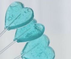 two heart shaped lollipops sitting on top of each other