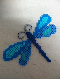 an image of a blue butterfly made out of perler beads