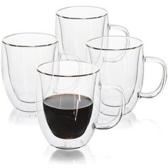 four clear glass mugs with black liquid in them