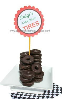 chocolate donuts stacked on top of each other in front of a sign that says causa della tires