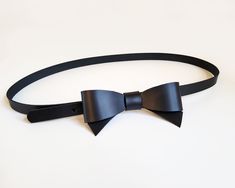 This beautiful and original belt is made of black firm natural leather. The leather bow on the front will perfectly accentuate your waist and highlight your personal style. The belt will look great on dresses and skirts. Belt closes with metal snap, which is hidden under leather bow- put belt tail through the loop and close it. The belt has three holes to adjust  your waist. ( In the video is a little bigger version of this belt) The size chart shows the waist circumference from the first hole t Chic Black Corset Belt For Formal Occasions, Chic Black Bow For Black Tie Events, Chic Black Bow Tie For Formal Occasions, Bow Belt, Leather Bow, Leather Bows, Suspender Belt, Waist Circumference, Black Colour