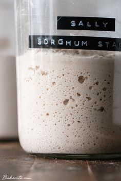 a glass jar filled with liquid sitting on top of a wooden table