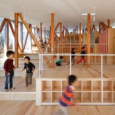 children are playing in an open space with wooden floors