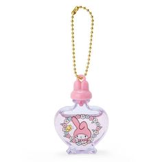 a small glass bottle with a pink bunny on the front and a gold chain hanging from it