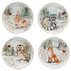 four plates with animals painted on them in the snow, one has an owl and two raccoons