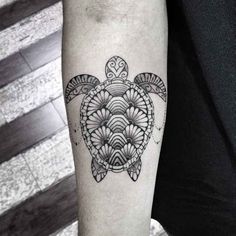 a turtle tattoo on the arm