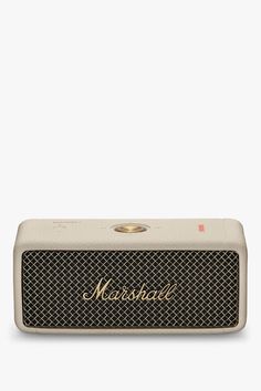 the marshall portable bluetooth speaker is shown in beige and has gold lettering on it