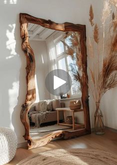 a large mirror sitting on top of a wooden floor