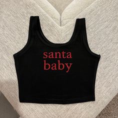 Super cute Santa baby crop top perfect for Christmas time and for cute family pijama pictures 🎄❤️ * the glitter material on these crop tops is professionally pressed and does NOT fall* ** DISCLAIMER these tops run a bit small so please size up if in doubt ! ** Cute Crew Neck Tank Top With Letter Print, Cotton Letter Print Party Top, Cotton Tops With Letter Print For Party, Party Top With Letter Print In Cotton, Cotton Party Tops With Letter Print, Fitted Black Christmas Top, Fitted Black Top For Christmas, Red Sleeveless Christmas Top, Red Sleeveless Top For Christmas