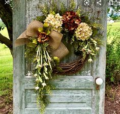 a door with a wreath and flowers on it