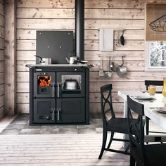 a black stove sitting inside of a kitchen next to a table