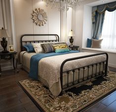 a bedroom with a bed, chandelier and rug on the floor in front of a window