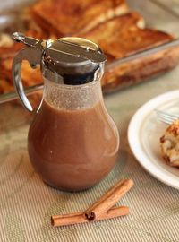 there is a small carafe and some food on the table