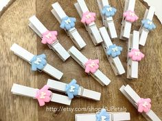 several clips with bows on them are sitting on a table next to a wooden board