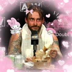 a man with tattoos is holding a box and talking into a microphone while surrounded by hearts