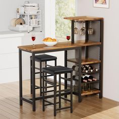 a kitchen table with two stools next to it and wine glasses on the counter