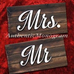 two wooden signs with the words mrs and mr written in white ink on red velvet