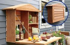 a wooden birdhouse hanging from the side of a house