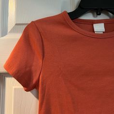 New Without Tags H&M Size Medium Thick Material Ribbed Shirt Really Nice Orange Color Somewhat Fitted Cut Pit To Pit Measures 14.5 In Length 20 In 3/$48 Add 3 “3/$48” Listings To A Bundle And I’ll Send You An Offer For $48! Casual Orange Ribbed Top, Orange Ribbed Crew Neck Top, Fitted Orange Ribbed Top, H&m Ribbed Stretch Tops, H&m Cotton Tops For Fall, Basic H&m Tops, Casual Spring Tops By H&m, Trendy H&m Short Sleeve Tops, Orange Ribbed Tops For Spring