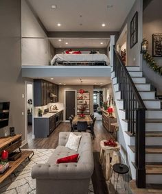 a living room filled with furniture and stairs