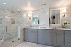 a large bathroom with two sinks and a walk in shower