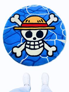 a person standing in front of a round rug with a skull and crossbones on it