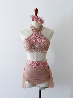 a dress on a mannequin with pink flowers in the top and bottom part