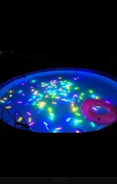 an image of a pool with lights on it and a frisbee in the water