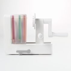 a toothbrush holder with four different colored tooth brushes in it's holder on a white surface