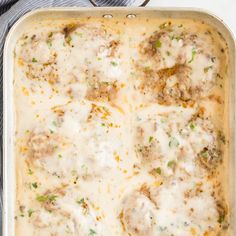 a casserole dish filled with meatballs and cheese