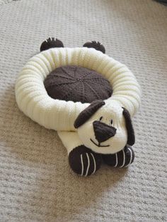 a dog toy laying on the floor with it's front paws in its mouth