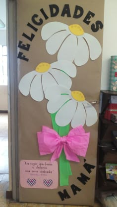 a door decorated with flowers and a pink bow