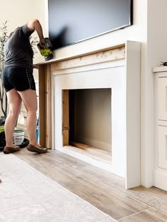 a man sanding up a fireplace in his living room