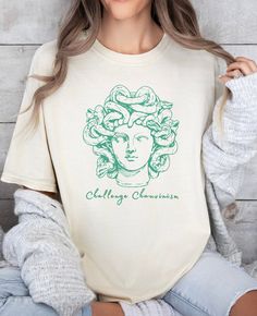 We love our comfortcolors tshirt featuring the Gorgon Queen, Medusa!  She rocks this along with the phrase "Challenge Chauvinism" and hope you will too!  Perfect for someone who wants to show their feminism or feministic spirit.  Let's reclaim Medusa's story and as a symbol of power & strength and use her image as a symbol of protection against evils! * Q U I C K * F A C T S * ✺ Pre-shrunk 100% US cotton for size retention using cotton that is ethically grown and harvested.  ✺ The relaxed fit ke Cute Greek God Shirts, Medusa Story, Light Academia Clothing, Selling T Shirts, Queen Medusa, Academia Clothing, Preppy Stuff, Clean Girl Aesthetic, Power Symbol