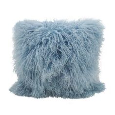 a blue furry pillow on a white background