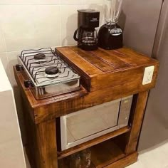 a microwave oven sitting on top of a wooden shelf