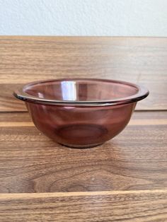 a brown bowl sitting on top of a wooden table