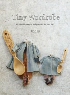 the cover of tiny wardrobes, featuring two wooden spoons and a doll's outfit