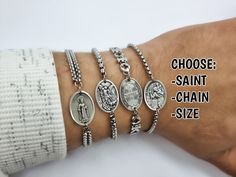 "Catholic saint chain bracelets, handmade in Medjugorje, by a member of our family. Choose your chain style and size of bracelet in dropdown menus. Type saint charm in the personalization tab (Photos 3, 4, 5) Every bracelet is adjustable to fit several wrist sizes. (Photo 6) Message card of Holy Lady from Medjugorje included. Also a free Medjugorje powers card with every multi item order. NOTE: We also have Custom Gift Cards, all You need to do after purchase is to send us message via \"note to Handmade Stainless Steel Chain Bracelet As A Gift, Customizable Silver Spiritual Bracelets, Saint Bracelet, Saint Medals, Catholic Bracelet, Chain Bracelet Silver, Custom Gift Cards, Catholic Saint, Catholic Jewelry