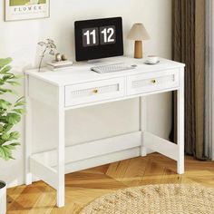 a white desk with a clock on it next to a potted plant and lamp