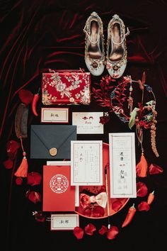 a table topped with lots of red and white items on top of a black surface